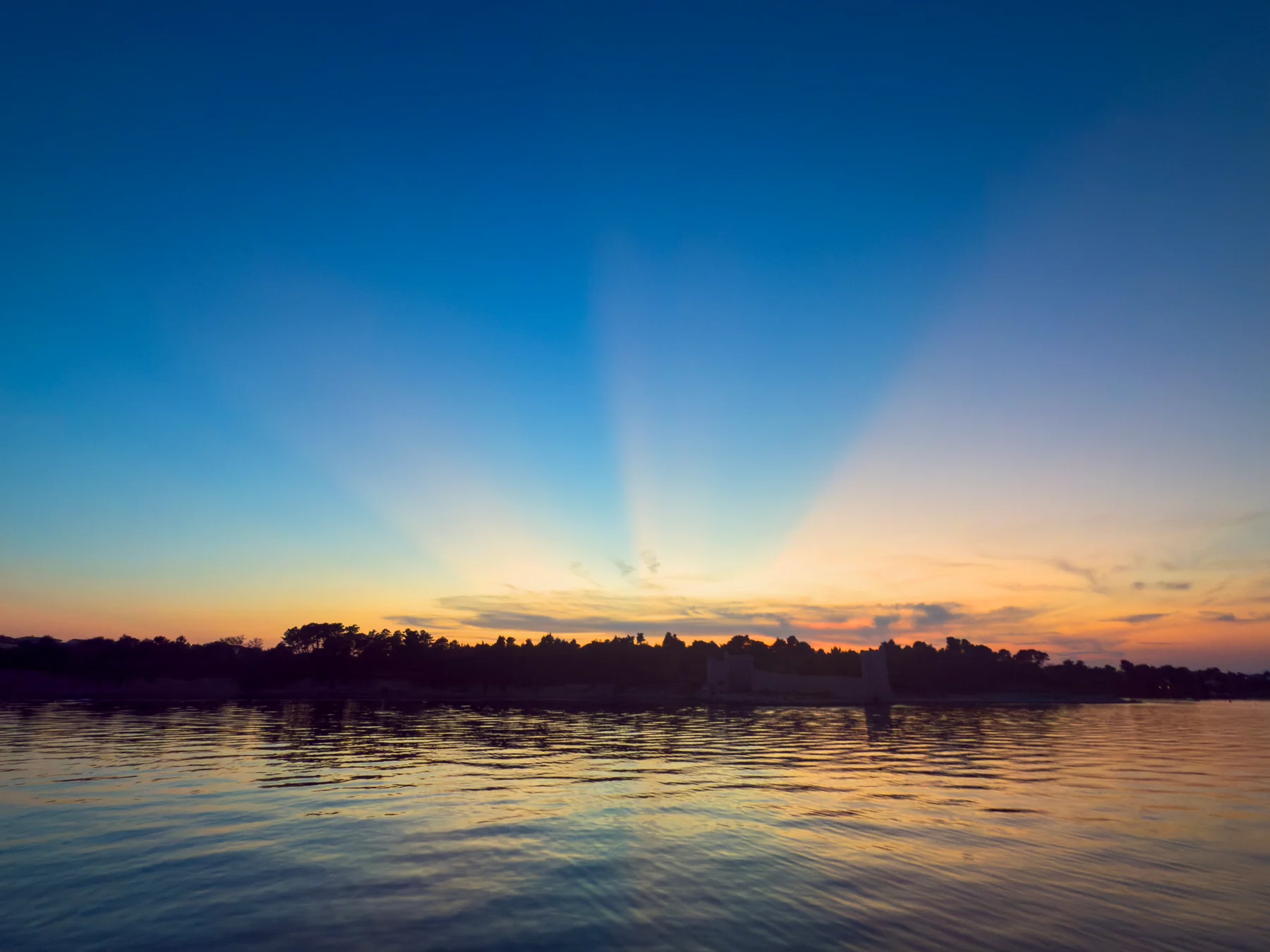 Calm wooded lake at sunset representing Lake Murray living