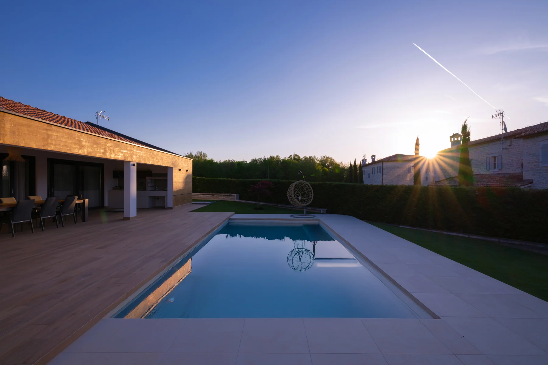 Modern residence and outdoor living space illuminated at night